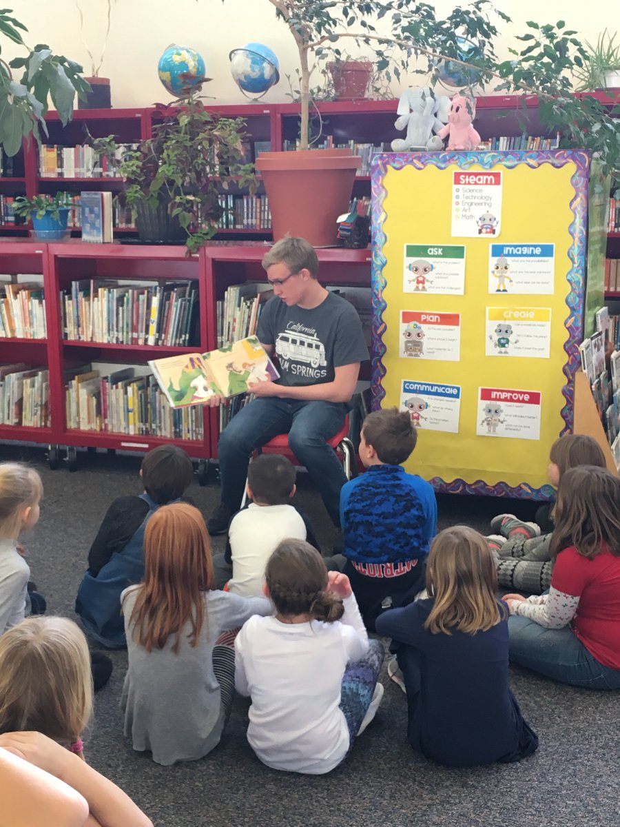 A University of Wyoming swimming student-athlete serves the community by reading to Linford Elementary children.