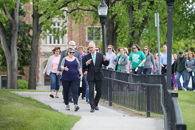 LEADING THE CHARGE—University of North Dakota President Mark Kennedy (front, right) leverages his corporate and congressional careers in managing a major employer and sustaining political and community support for the university.