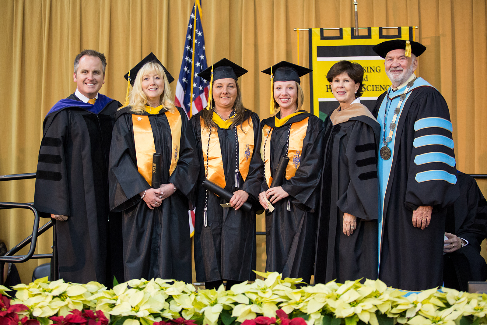 Tyler Junior College made history on Dec. 8, 2017 after pursuing course scheduling best practices. The system awarded its first-ever Bachelor of Science degrees during its fall commencement ceremony. From left: Texas State Sen. Bryan Hughes, commencement speaker and 1989 TJC alumnus; Bachelor of Science degree recipients Michelle Trammell of Tyler, Shannon Kassaw of Palestine, and Amanda Camp of Lufkin; then-TJC Board President Ann W. Brookshire; and TJC Chancellor Dr. Mike Metke.