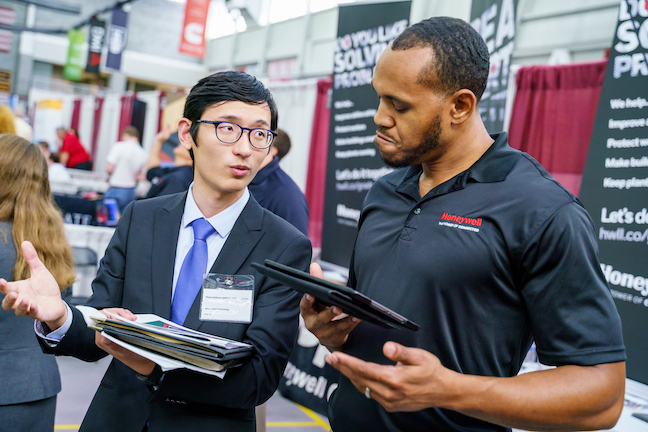 A student speaks with a potential employer at a career fair at Rose-Hulman Institute of Technology. Enrollment of Chinese college students at the Indiana institution, which has about 2,000 undergrad students, dropped by about 40 this year.