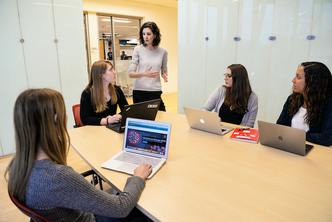 Sacred Heart University Professor Sofia Pendley (standing) is leading students in generating weekly coronavirus reports for local health officials. (Photo: Tracy Deer-Mirek)