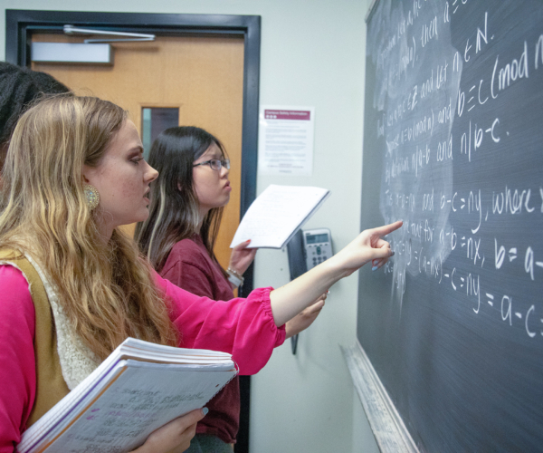 Meredith College students work out a math problem prior to the COVID pandemic. (Photo: Meredith College Marketing Department)